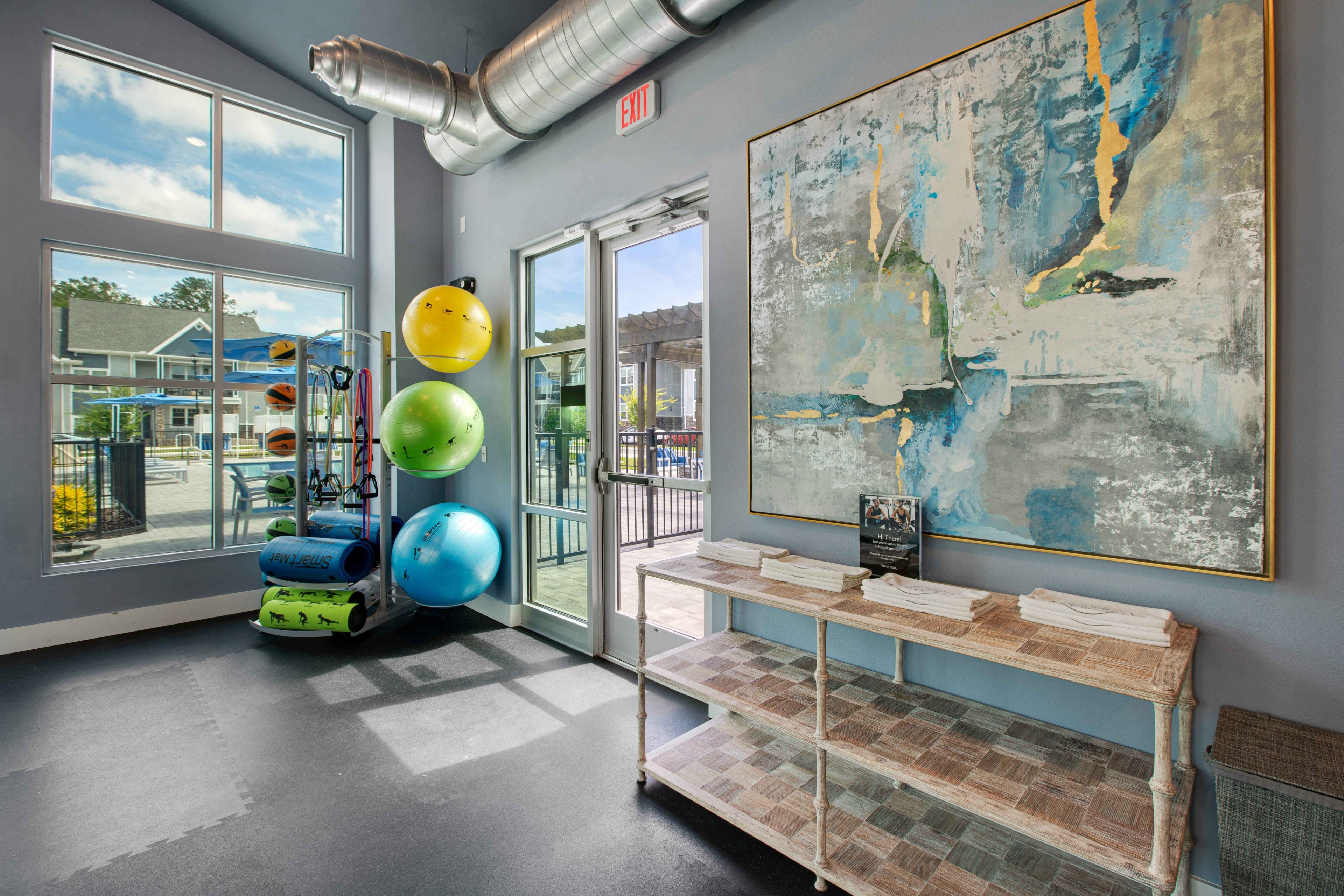 a gym with a weights rack and a large map on the wall