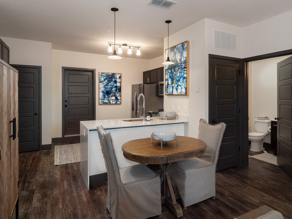 an open kitchen and dining room with a table and chairs