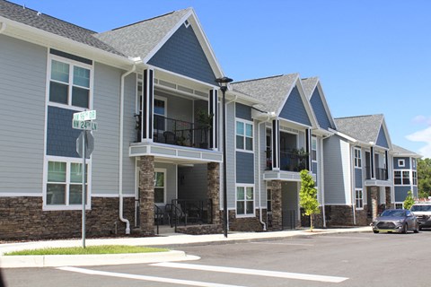 a row of houses on the corner of a street