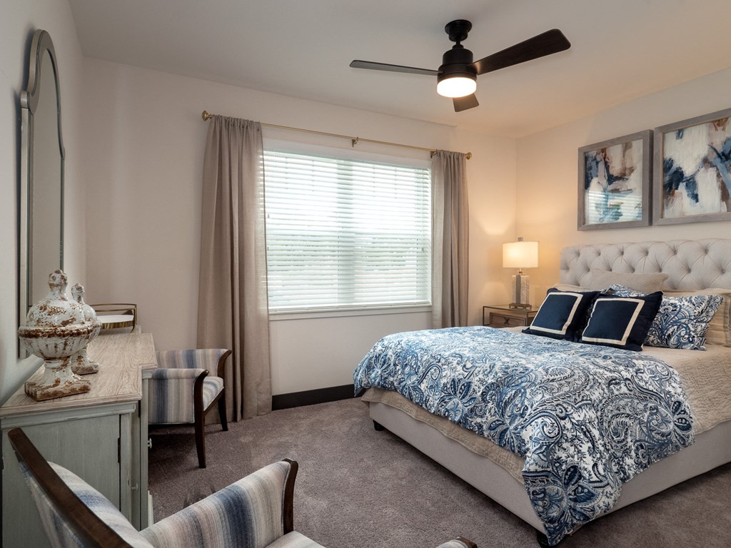 a bedroom with a bed and a ceiling fan