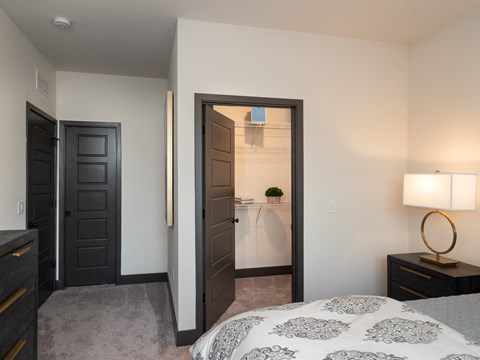 a bedroom with a bed and a door to a bathroom