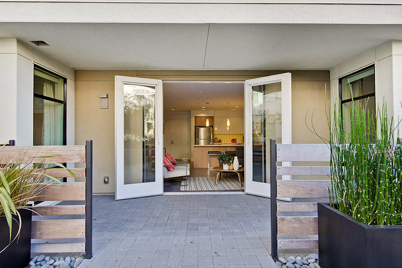 Apartments for Rent in Campbell - Revere Campbell - Patio with Double Glass Doors, Outdoor Tile Flooring, and Plants