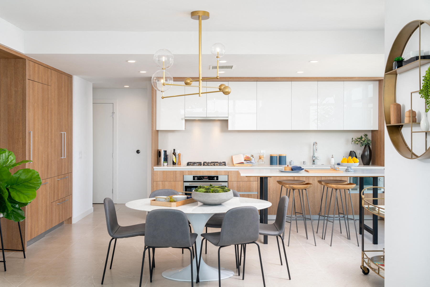 A modern kitchen with a dining table and chairs.