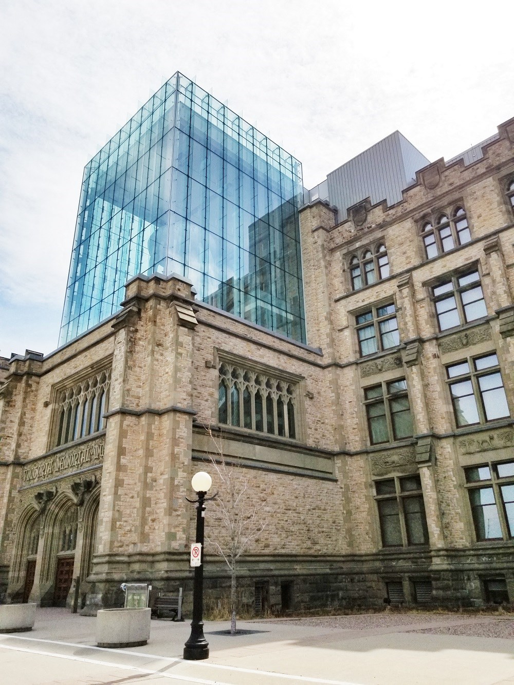 an old building with a tall glass building behind it