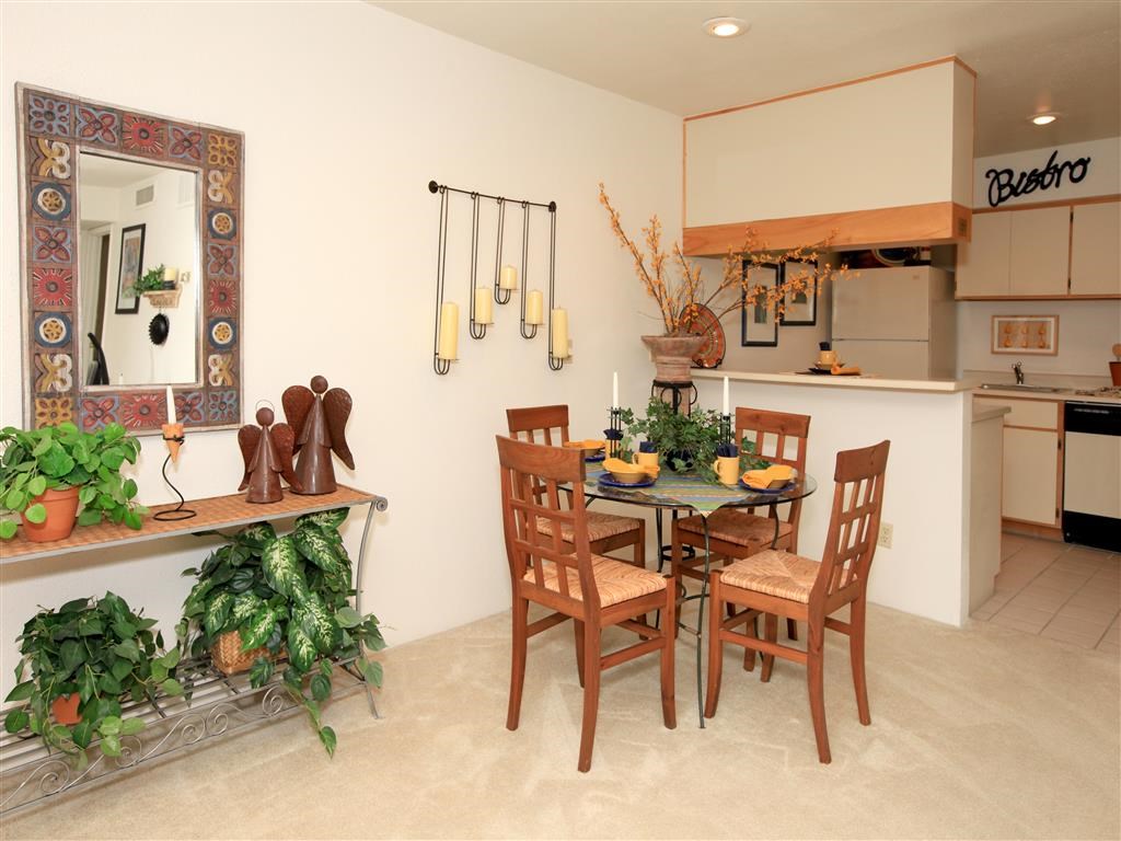 a dining room and kitchen with a table and chairs