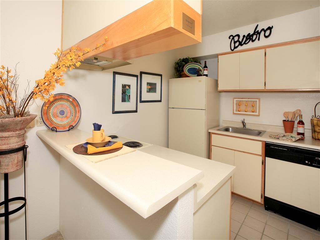 a kitchen with a counter top and a refrigerator