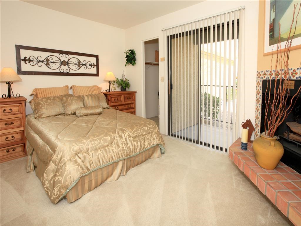 a bedroom with a bed and a fireplace