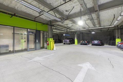 an empty parking garage with cars parked in it