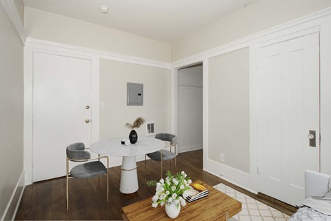 A white room with a table and chairs.