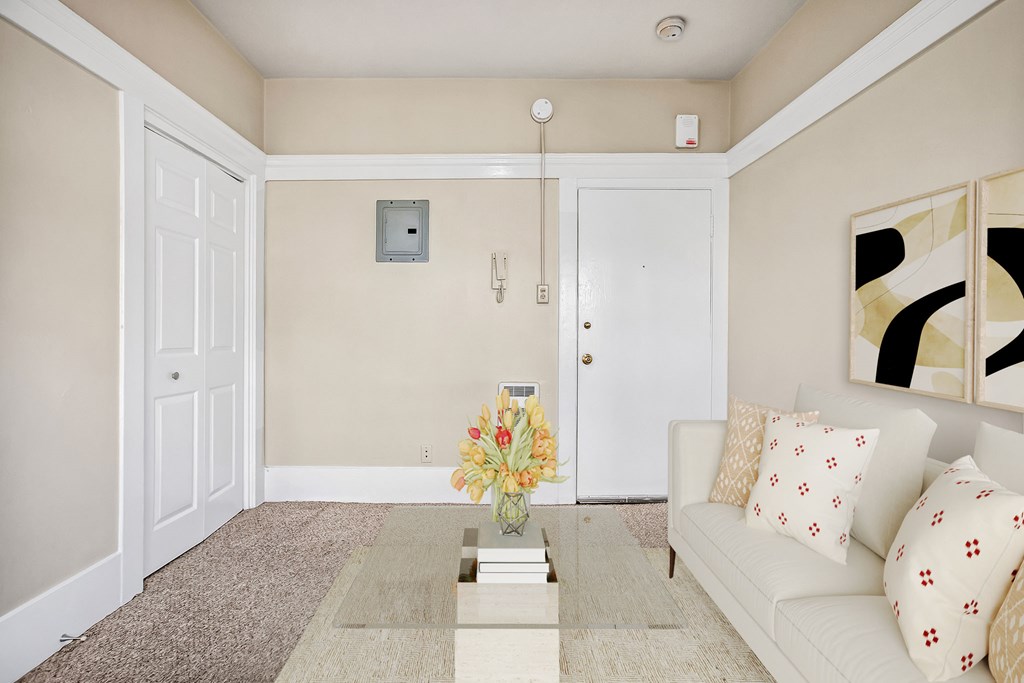 A living room with a white couch and a coffee table.