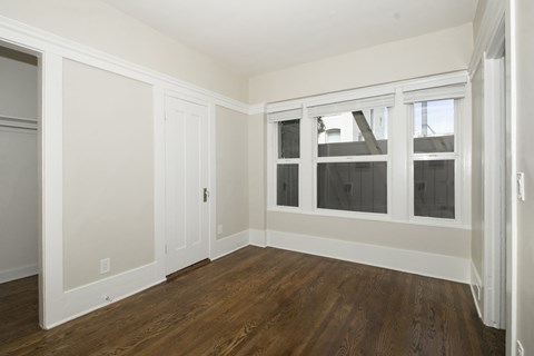 A room with white walls and wood flooring.