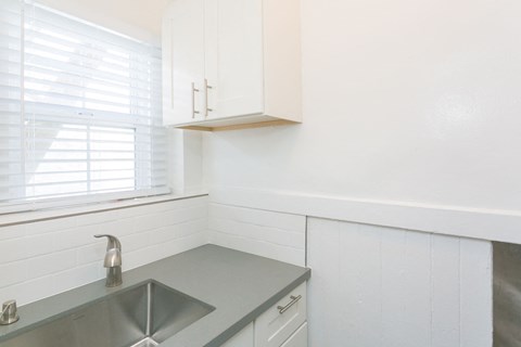 A kitchen with a sink and a window.