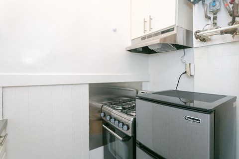 A modern kitchen with a stainless steel oven and range hood.