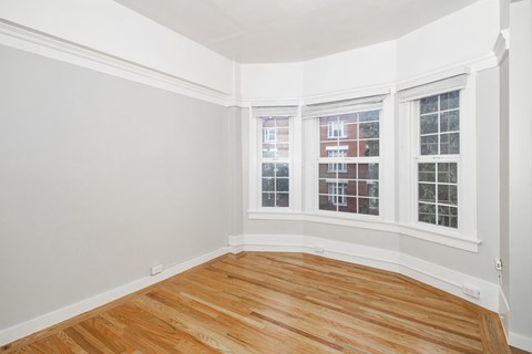 A room with wooden floors and white walls.