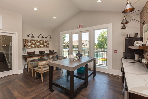 A kitchen with a table and chairs in the middle of the room.