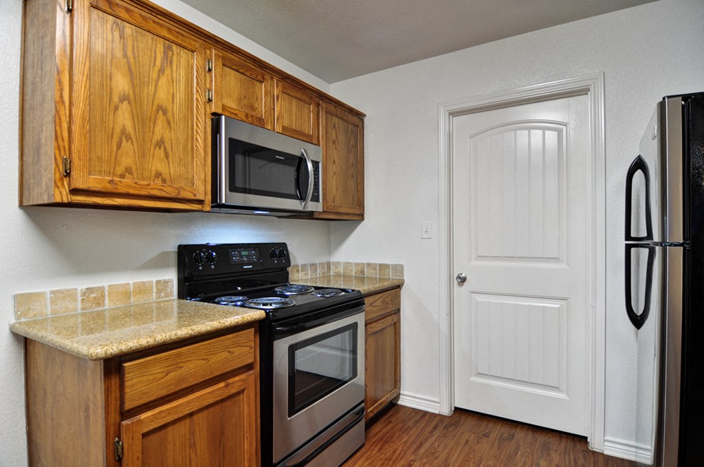 a kitchen with a stove microwave and refrigerator