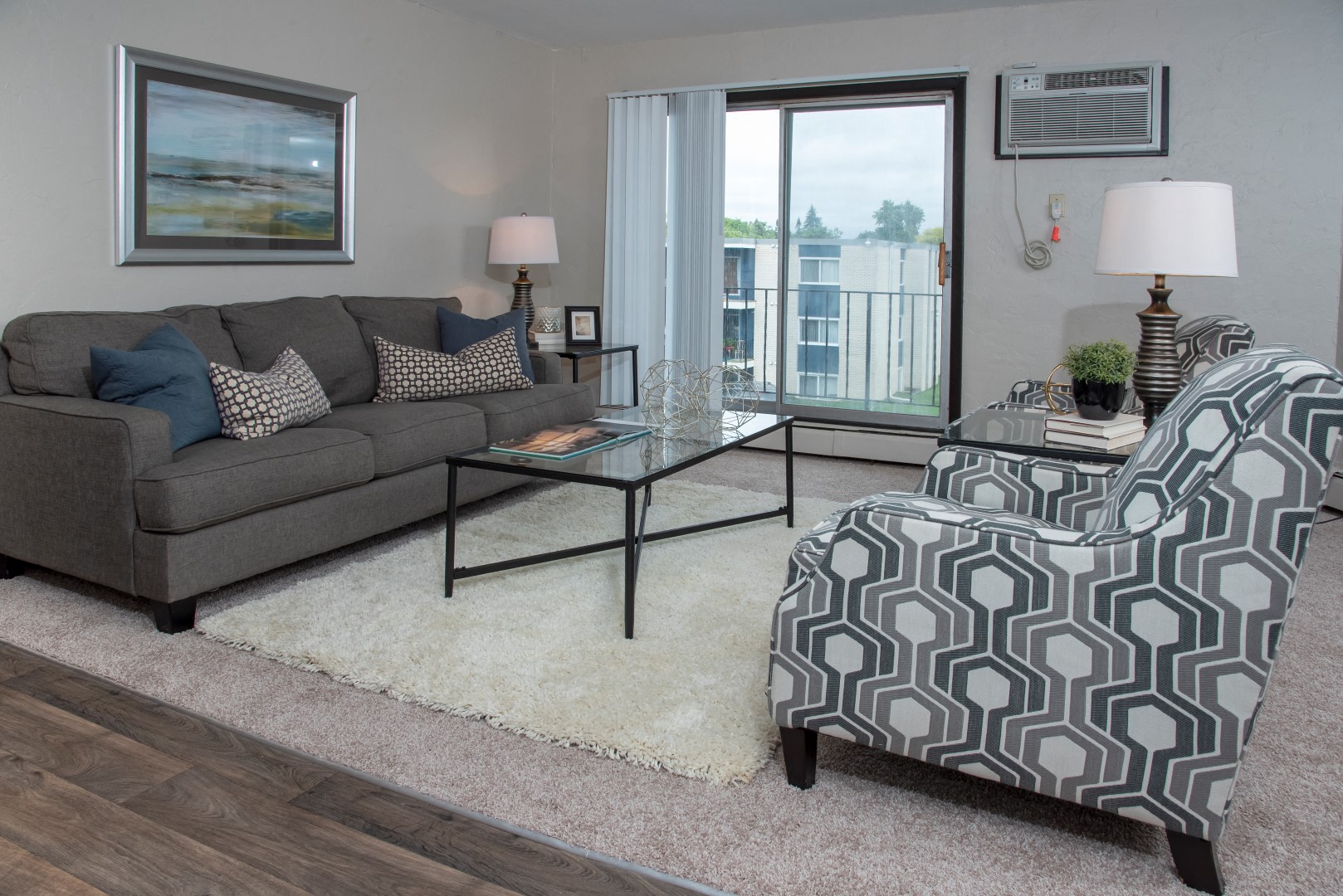 a living room with a couch and a chair and a table