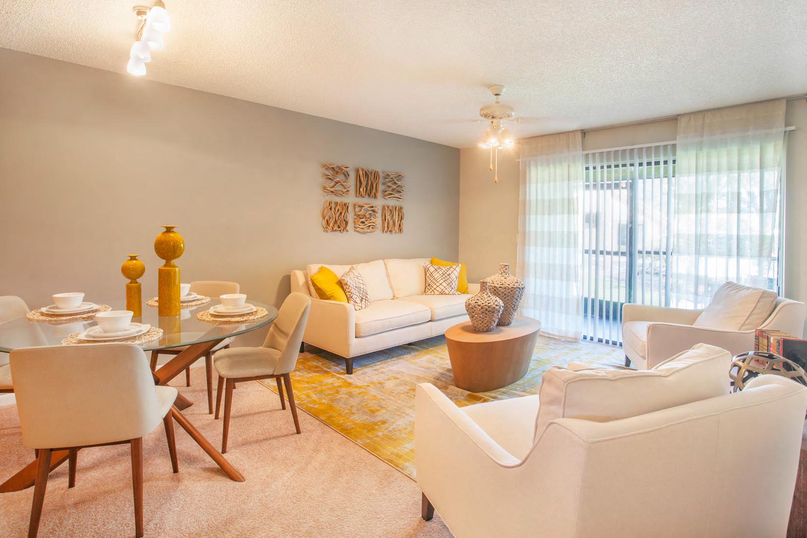 a living room and dining room with a table and chairs