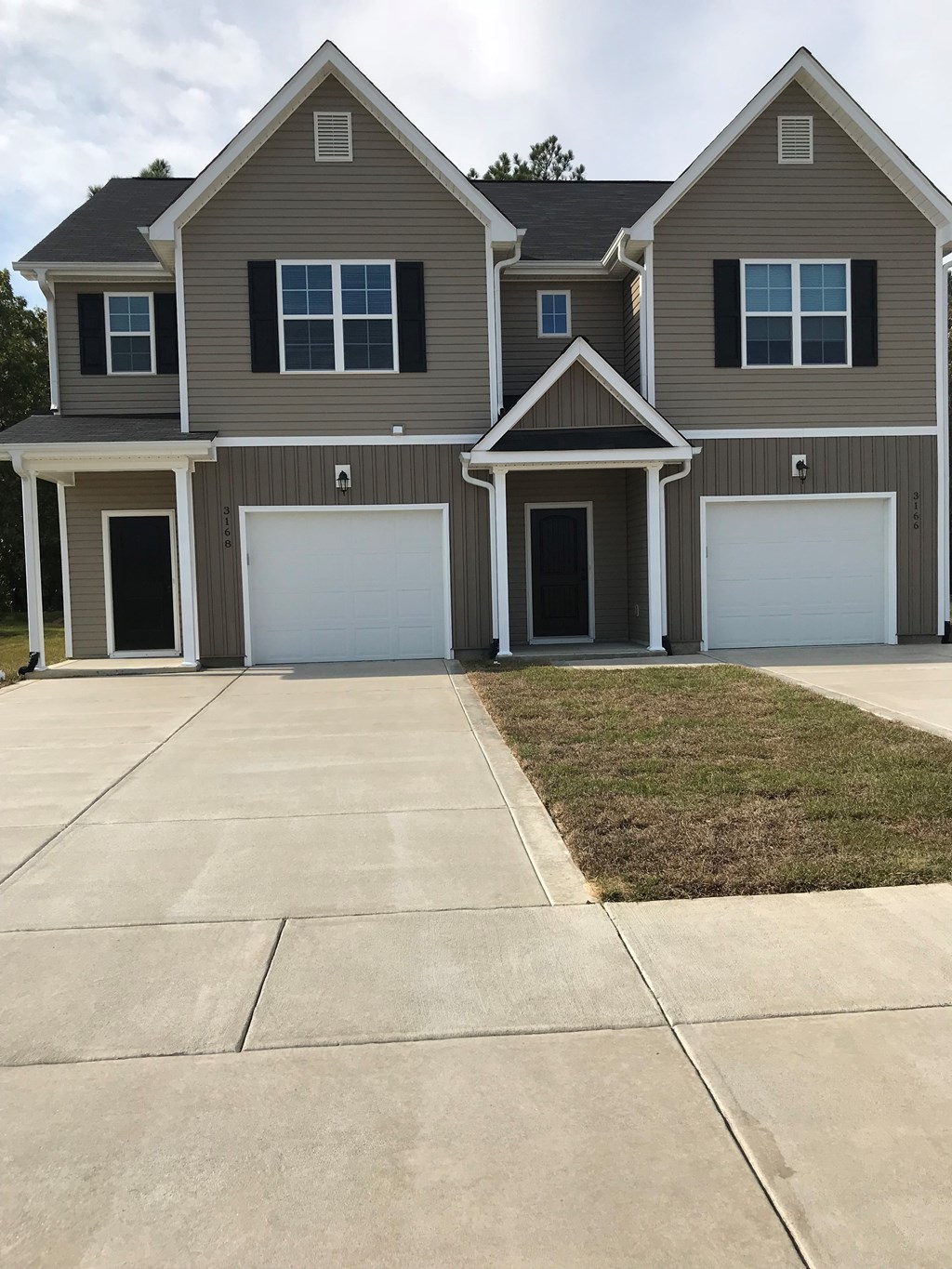 a house with two garage doors and a driveway