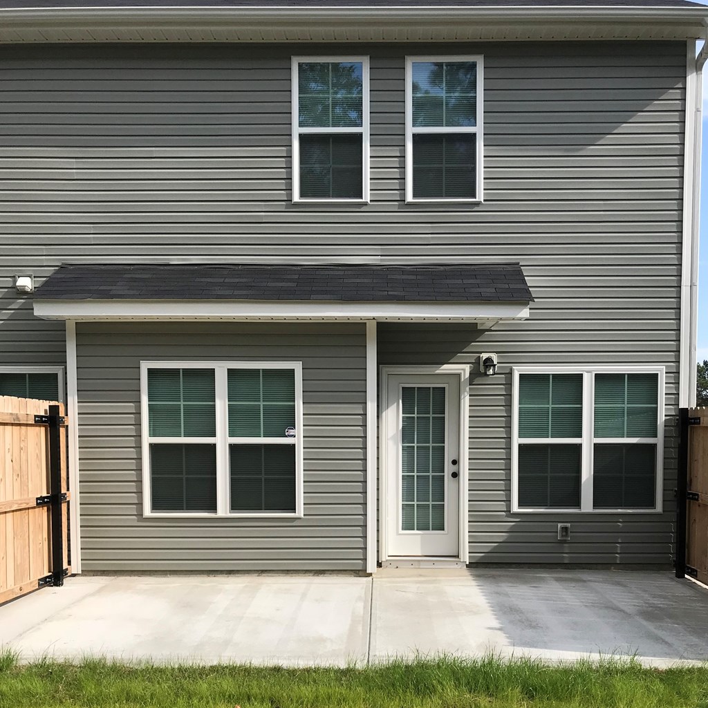 the front of a house with a porch and a door