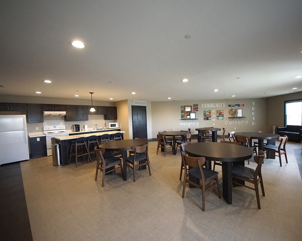 a large dining room and kitchen with a table and chairs