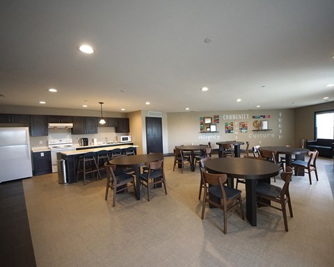 a large dining room and kitchen with a table and chairs