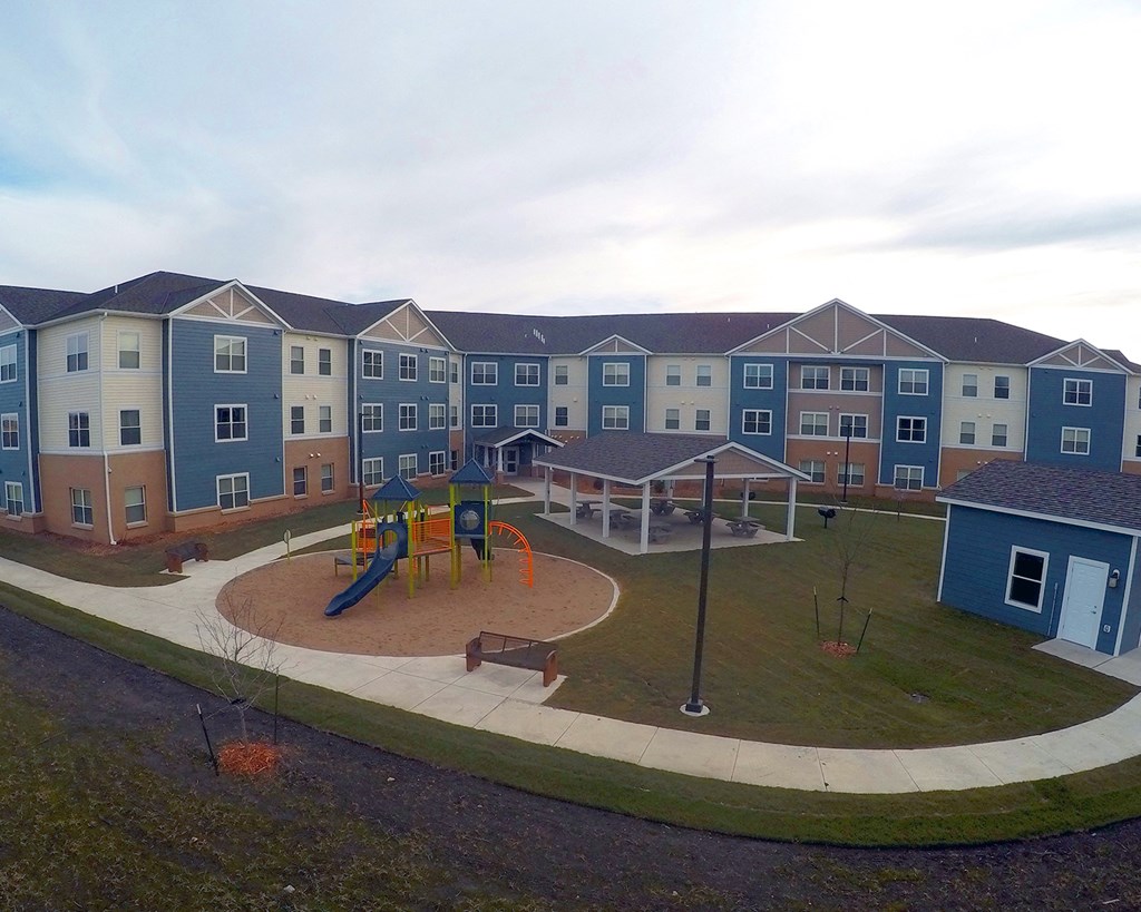an aerial view of an empty playground at an apartment complex