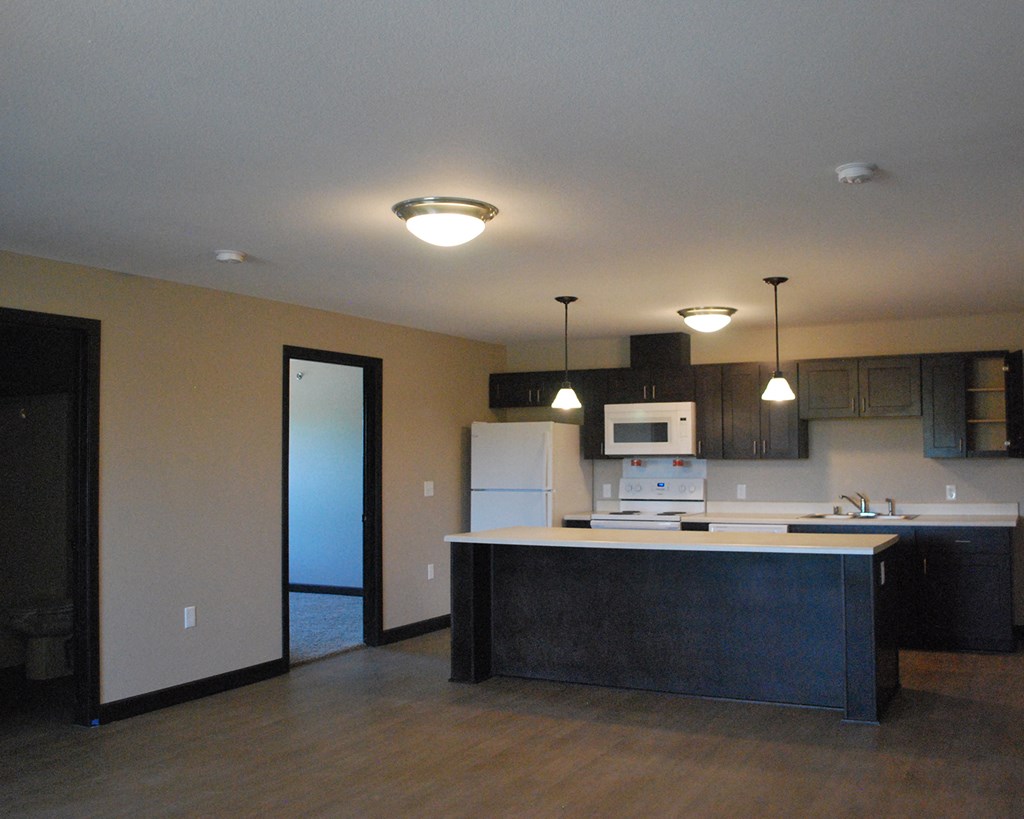 an empty kitchen with an island in the middle