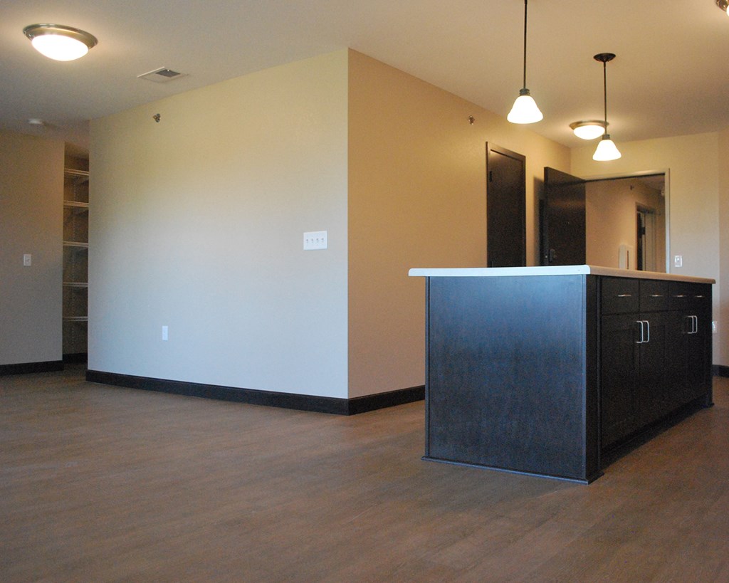 an empty living room with an island in the middle