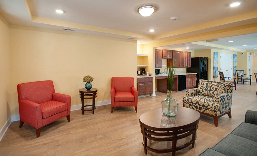 a living room with chairs and a table