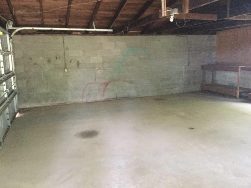 a basement with a concrete floor and a table