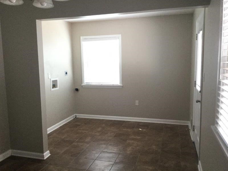 a empty room with a window and a tiled floor