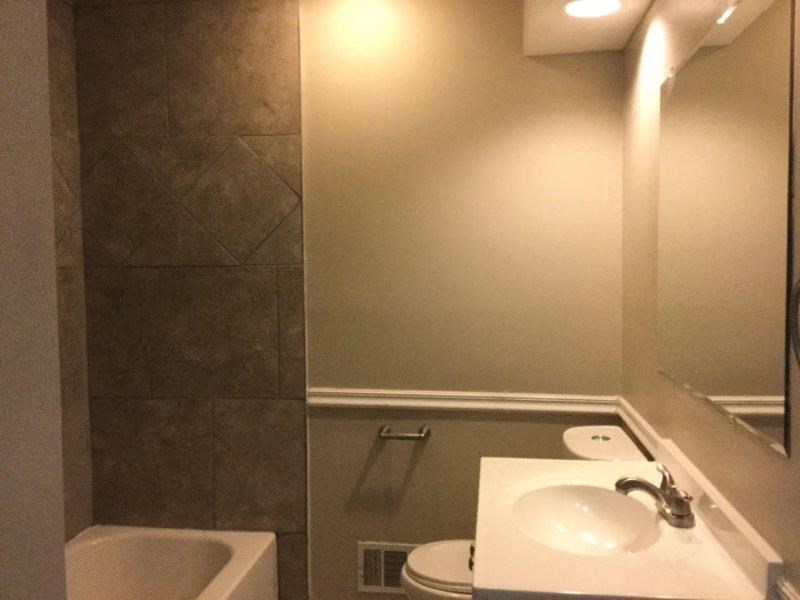 a bathroom with a sink and a toilet and a mirror