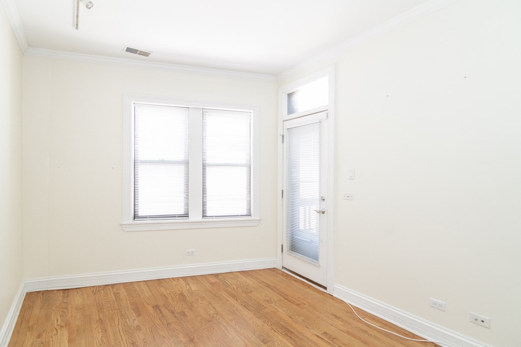 an empty room with white walls and a door and window