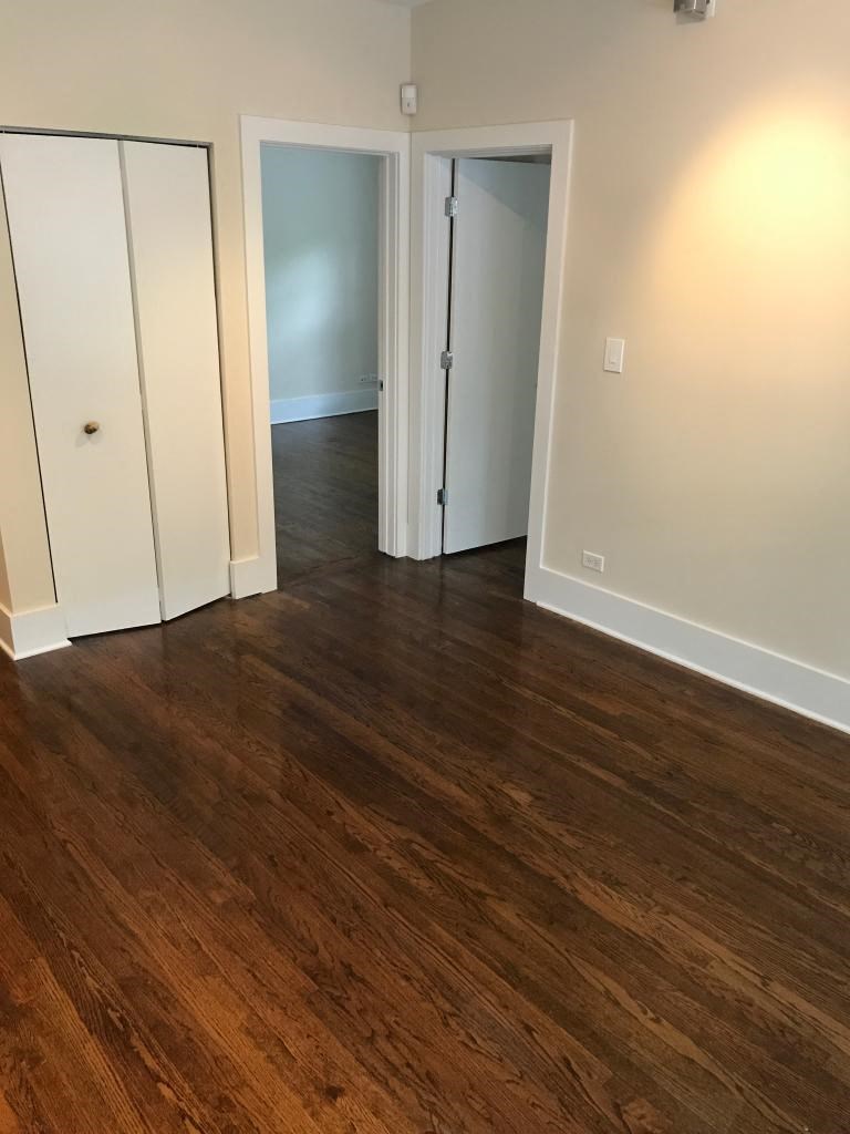 a living room with a hard wood floor and white doors