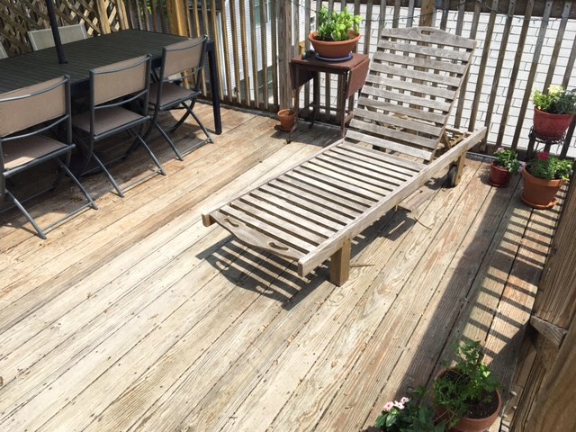 a wooden bench sitting on top of a wooden deck