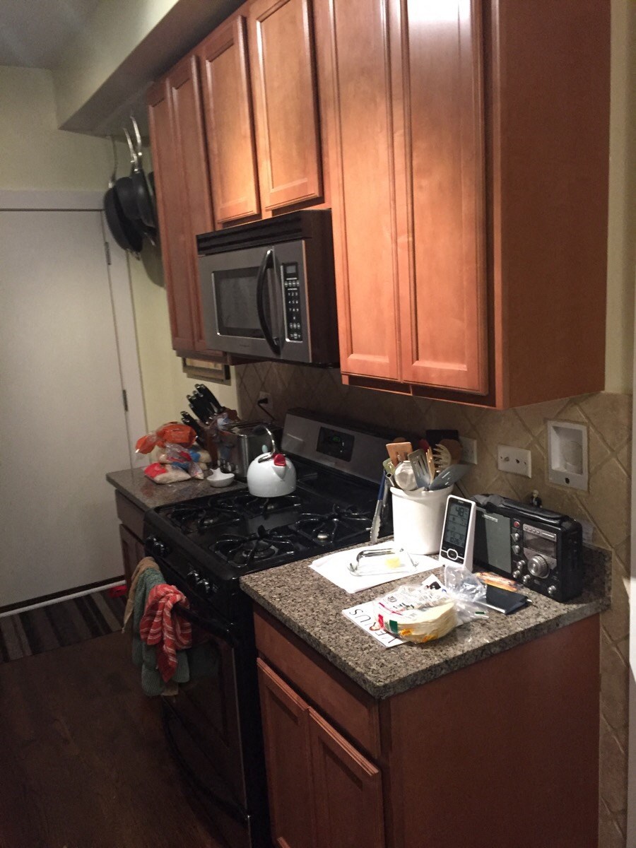 a kitchen with a counter and a stove and a microwave