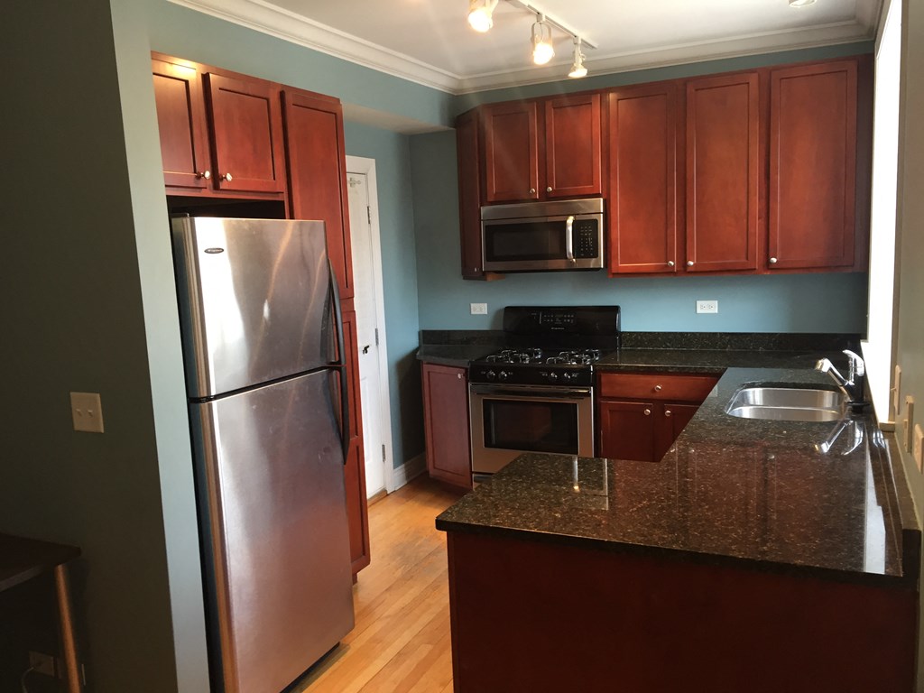 a kitchen with stainless steel appliances and granite counter tops
