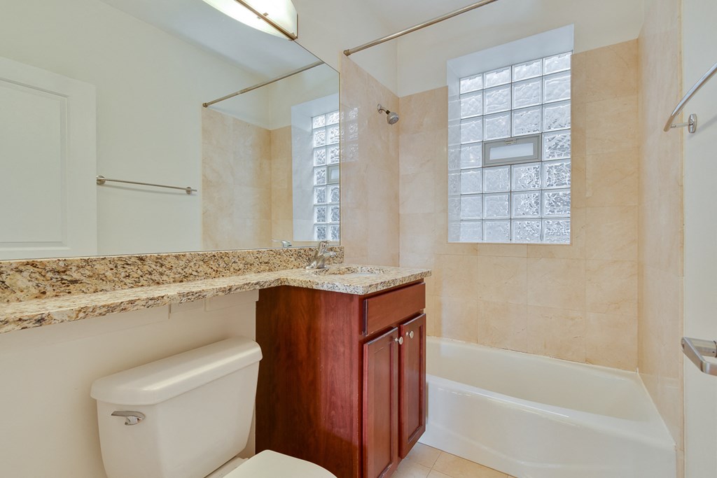 a bathroom with a sink and a toilet and a shower