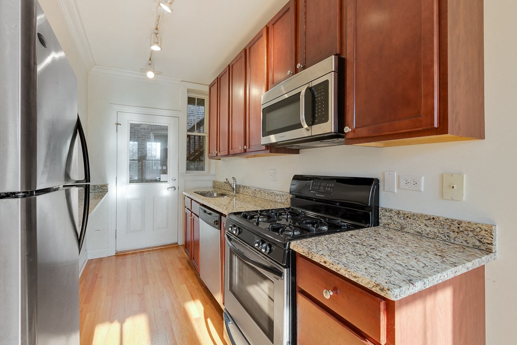 a kitchen with stainless steel appliances and granite counter tops