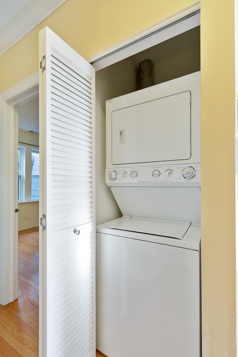 an empty laundry room with a washer and dryer