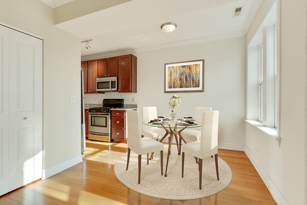 a dining room with a table and chairs and a kitchen