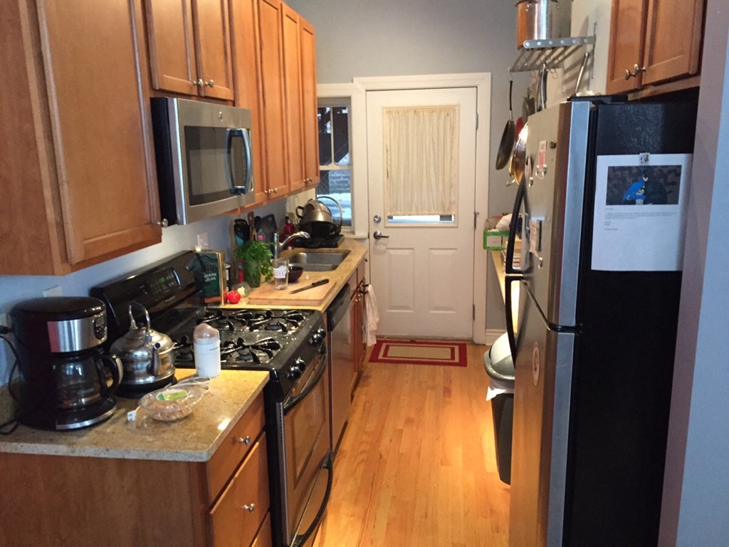 a small kitchen with a stove and a refrigerator