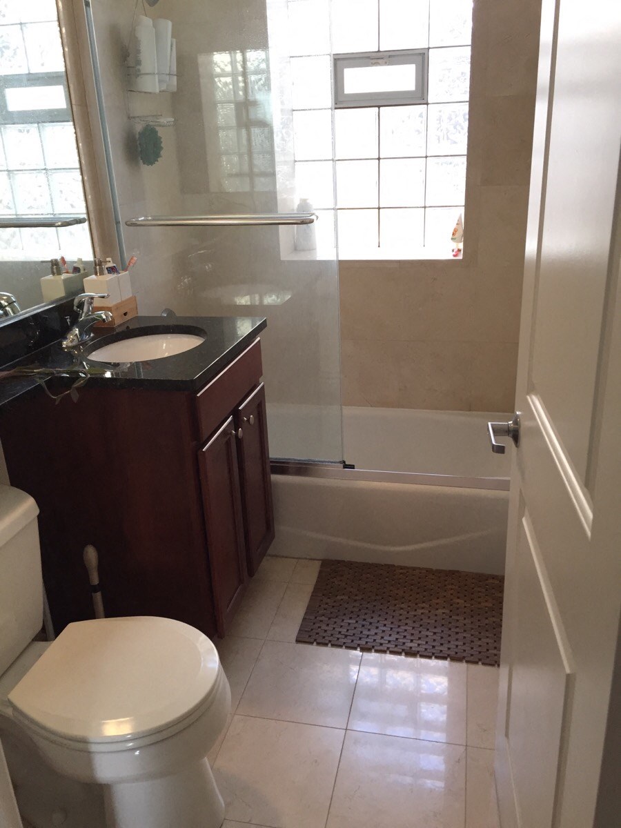 a bathroom with a toilet and a sink and a shower