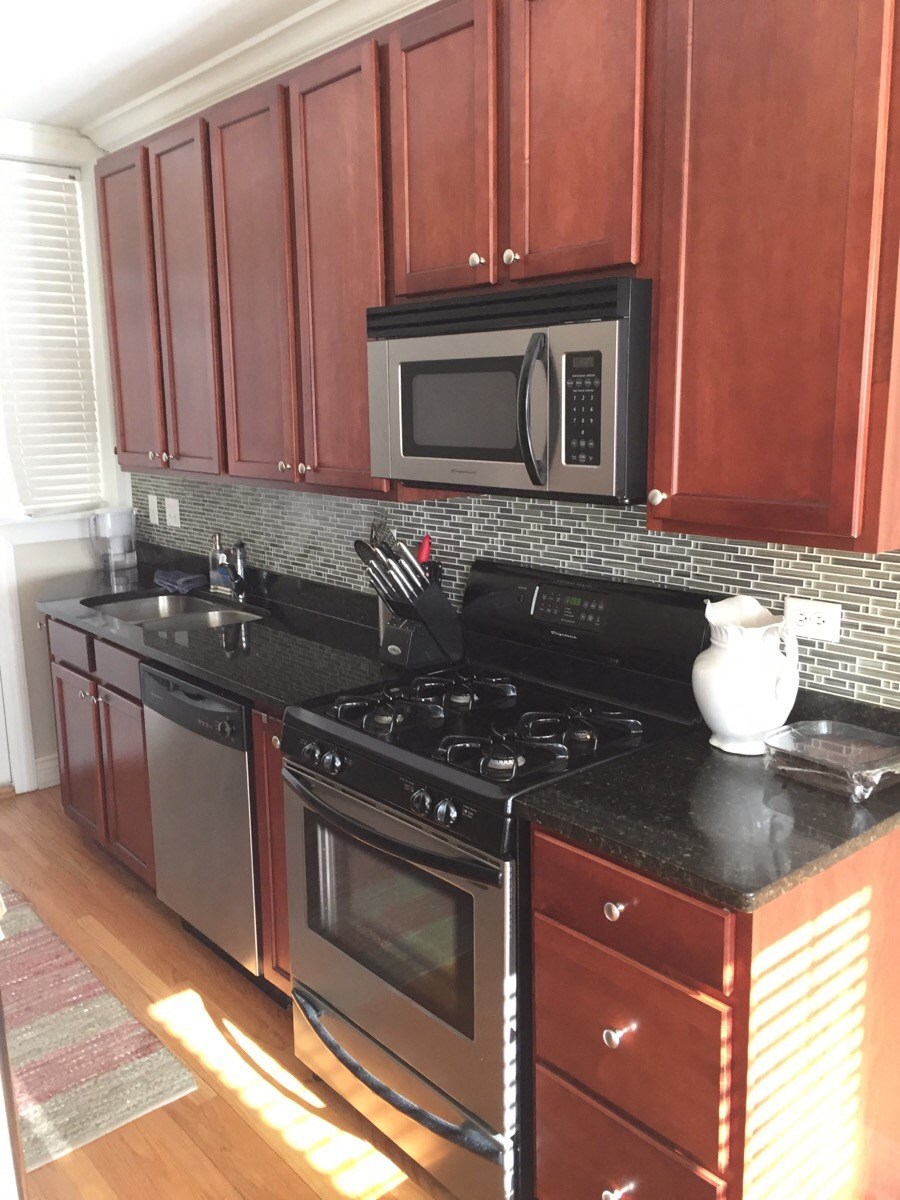 a kitchen with a stove microwave and cabinets