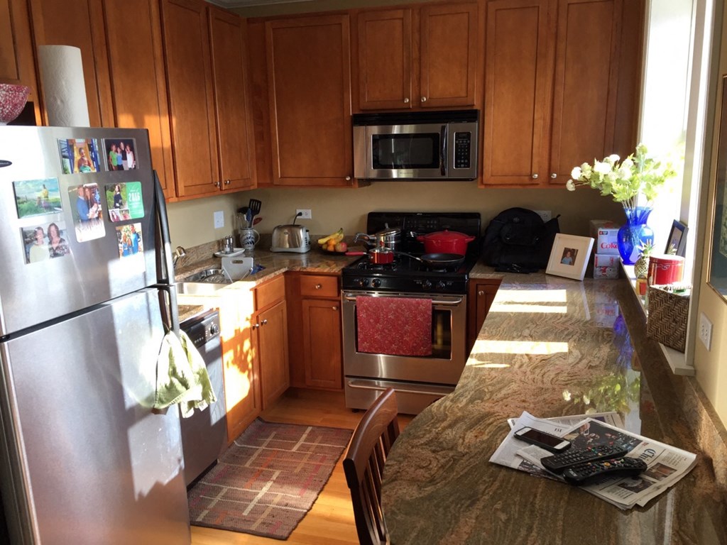 a kitchen with stainless steel appliances and wooden cabinets