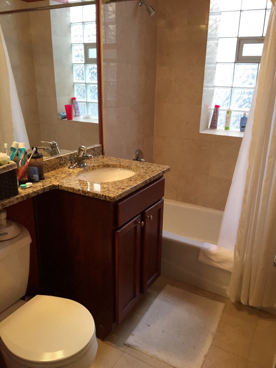 a bathroom with a toilet and a sink and a tub