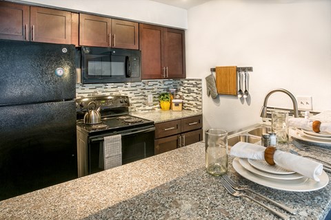 a kitchen with stainless steel appliances and granite counter tops
