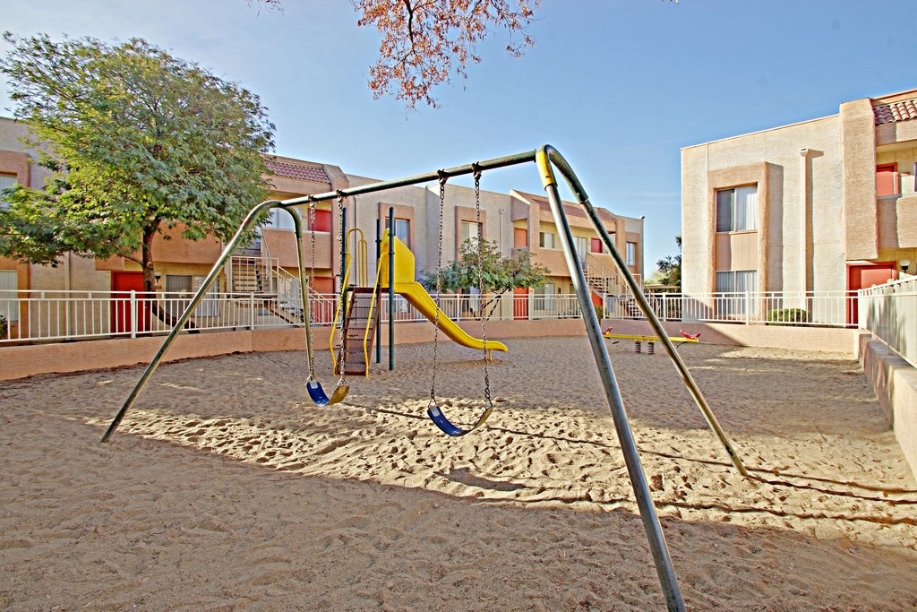 a swing set in a playground at a school