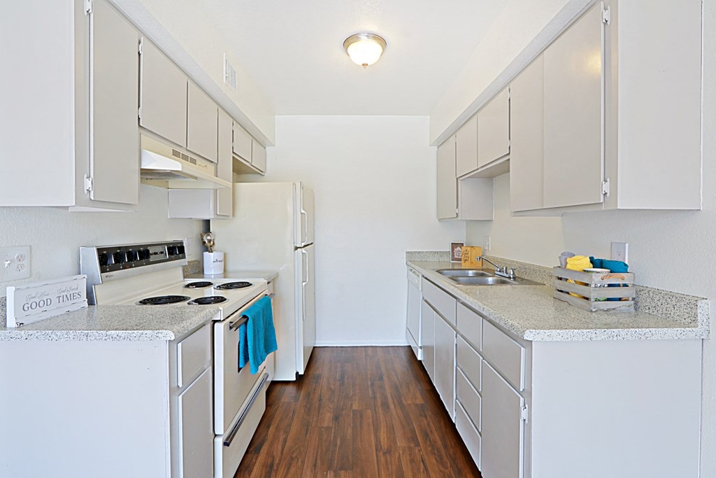 a renovated kitchen with white appliances and counter tops